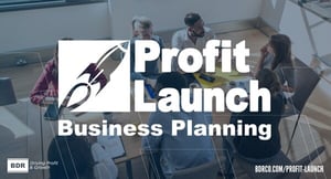 Group of people sitting around a table in a training room taking a solid crash course in business development. The words "Profit Launch Business Planning" overlay the image with a BDR logo in the bottom left corner.